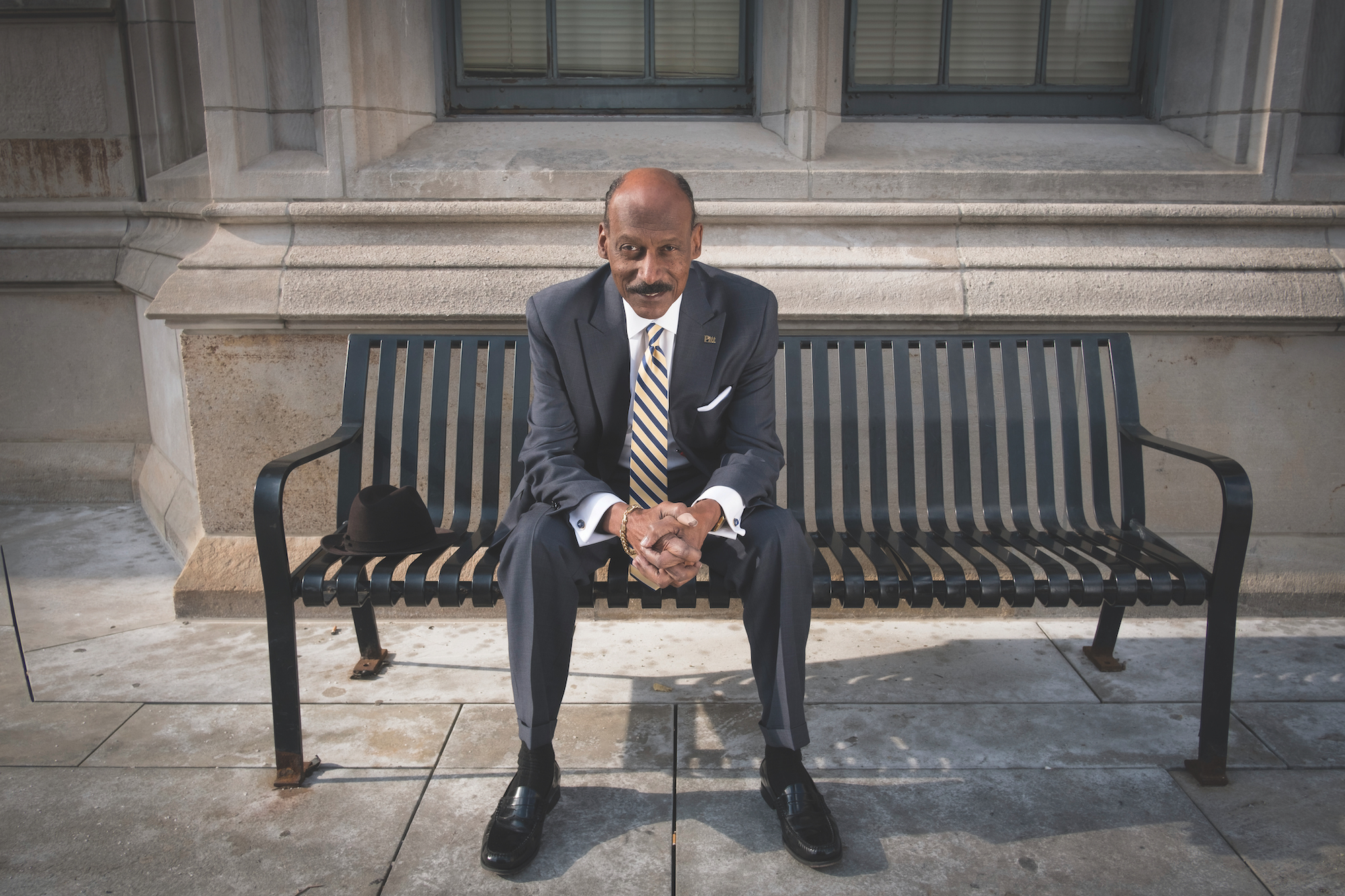 Dean Davis sitting on a bench outside the Cathedral of Learning