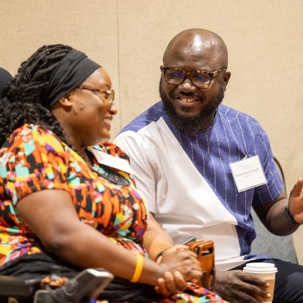 Daniel Abusuampeh talking to guest at event